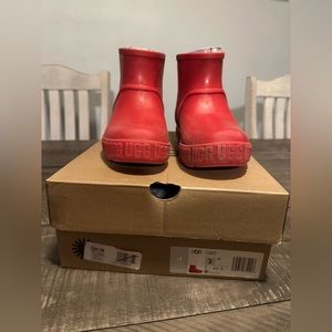 Girls red Ugg rain boots.